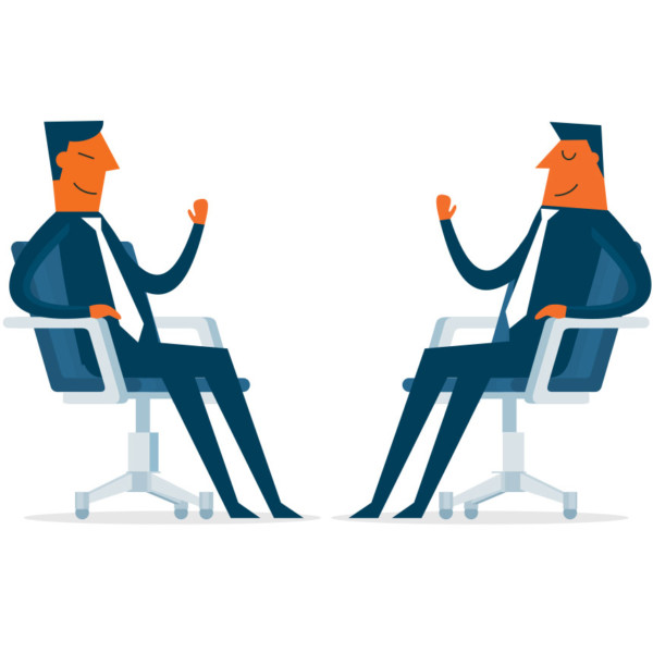 Image of two people sitting down in chairs having a meeting.