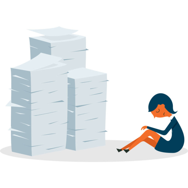 Image of someone sitting by a big pile of papers.