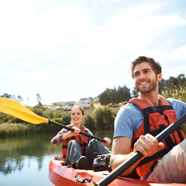 couple kayaking outdoors in a lake
