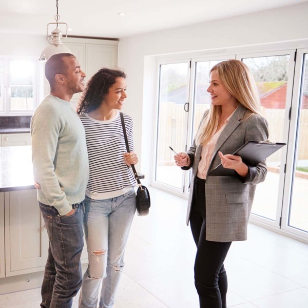 Couple speaking with a realtor about buying their new home