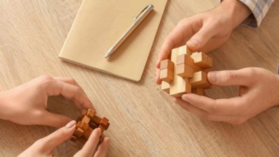 Image of people holding cube shaped puzzles.