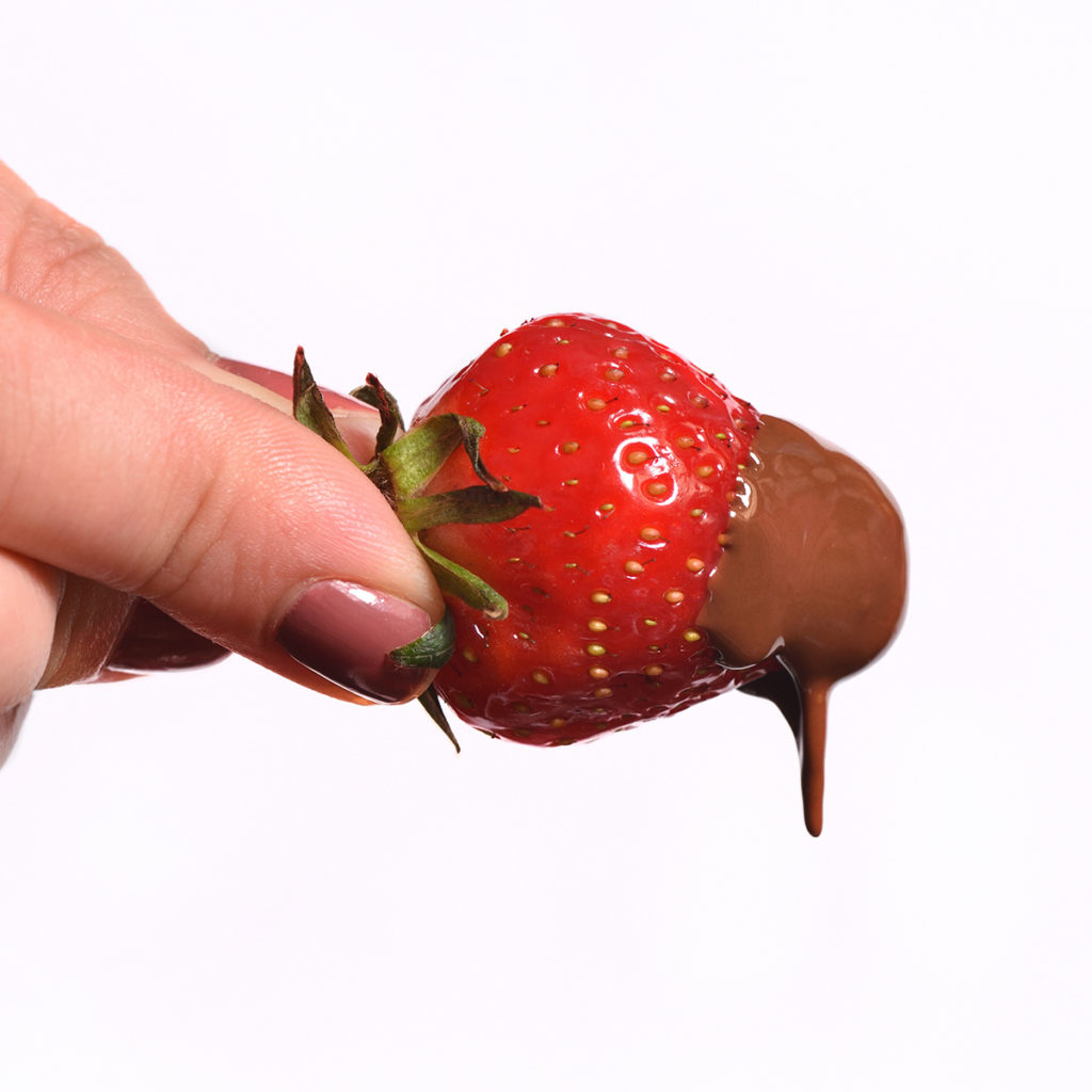 Strawberry that was freshly dipped in melted chocolate