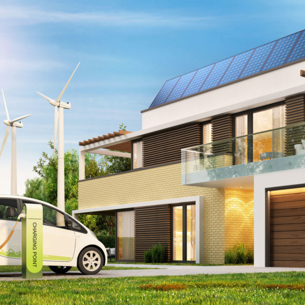 Image of the outside of a home with windmills and an electric car.