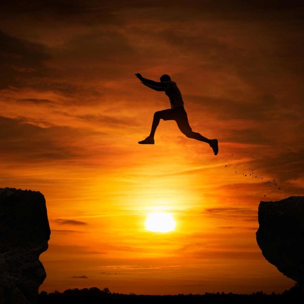 Image of someone who appears to be jumping from one cliff to another.