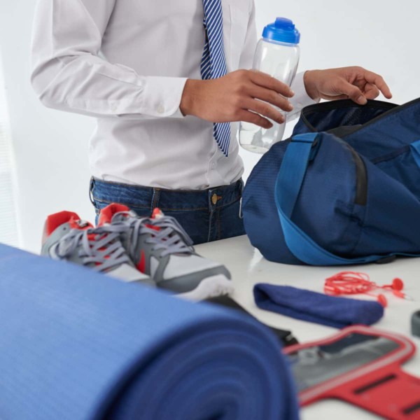 Man packing his gym bag so he can workout on the go