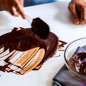 Moving chocolate around on the table with a spatula
