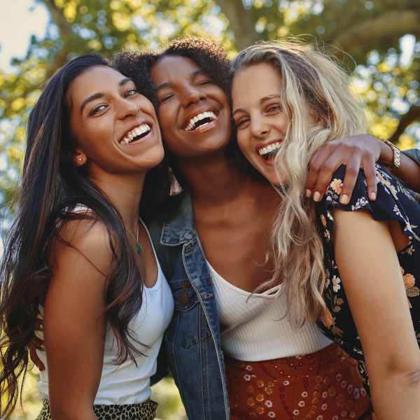 Group of 3 girls laughing and having fun to maintain their friendship