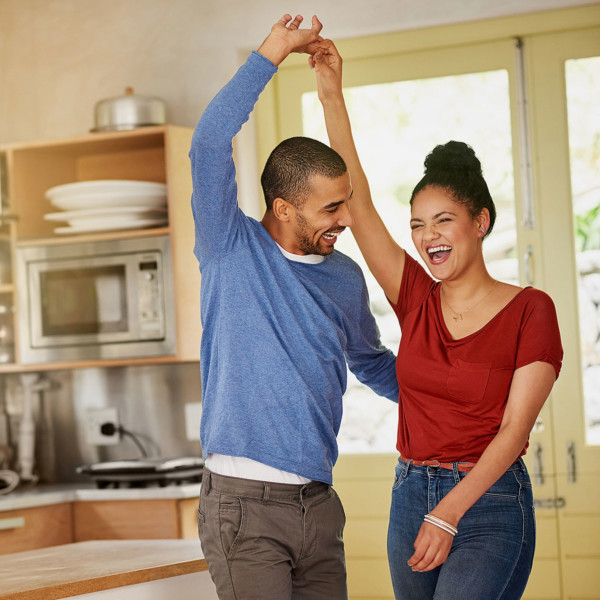 Image of a couple dancing together in the kitchen.