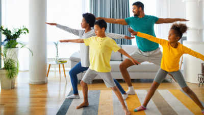 Family doing yoga in their living room