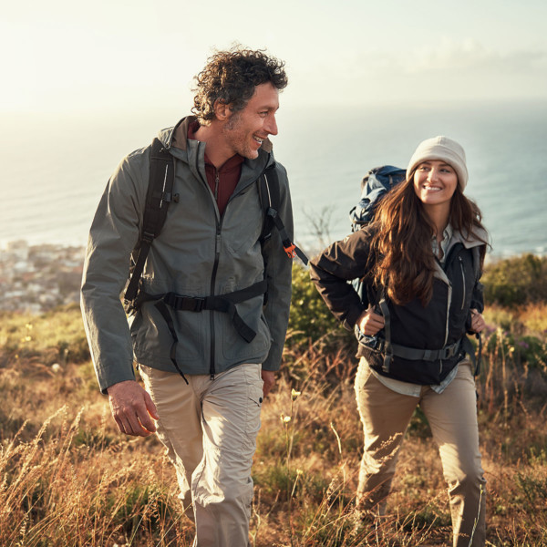 Image of two people on a date taking a hike.