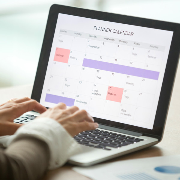 woman scheduling time to manage debt with planner