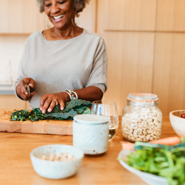 Woman chopping kale for salad