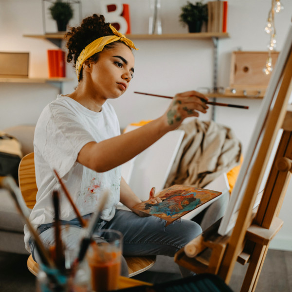 Woman finding her passion through painting in her studio