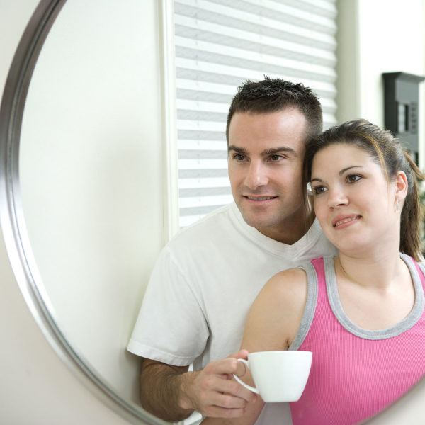 Image of a couple together looking into a mirror