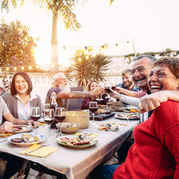 Image of family eating dinner at sunset outside