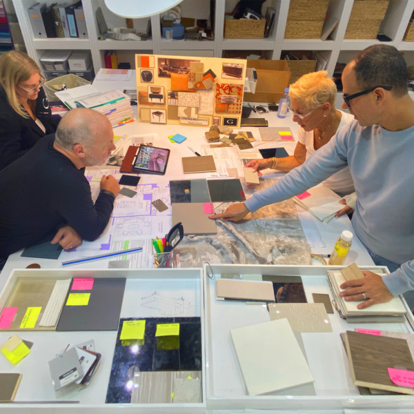 Marcus & Bobbi Lemonis working with team to on mood board to design home