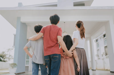 Image of a family looking at their home.
