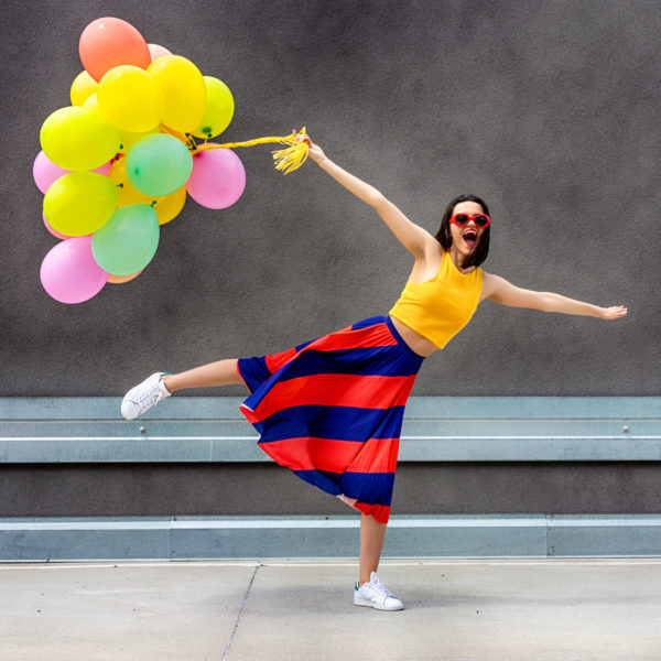 Image of a woman holding colorful balloons