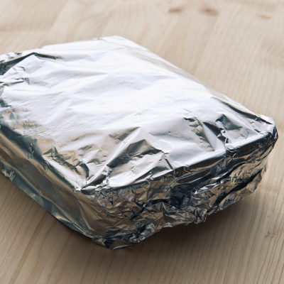 Dish covered in tin foil to put in oven to make chicken and rice dish