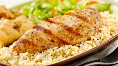 Close up of Greek chicken and rice with veggies